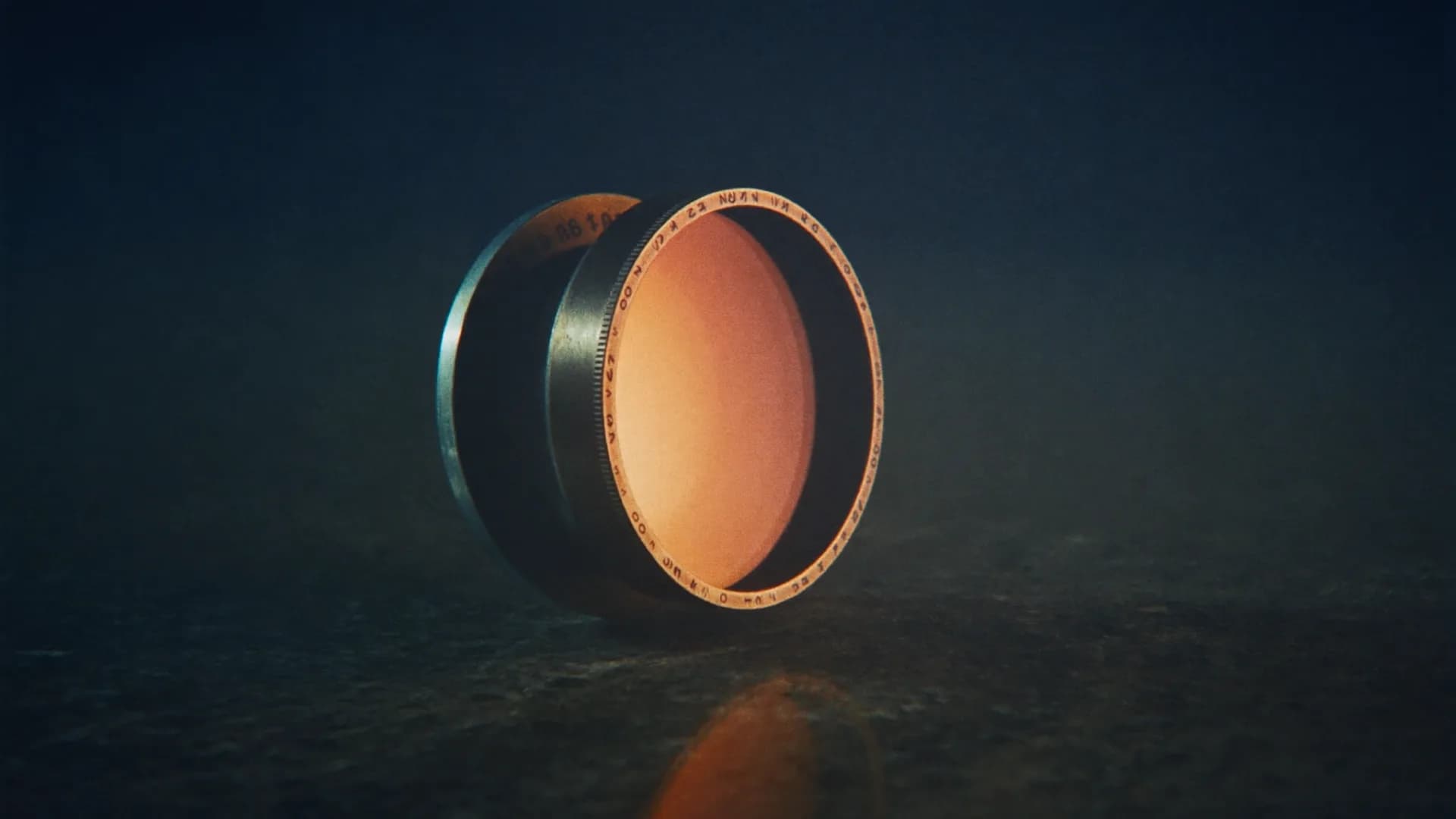 A lens standing in darkness, its glass filled with one warm circle of light